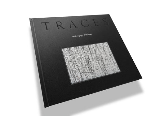Book titled 'Traces' with a black cover and white text on a white background