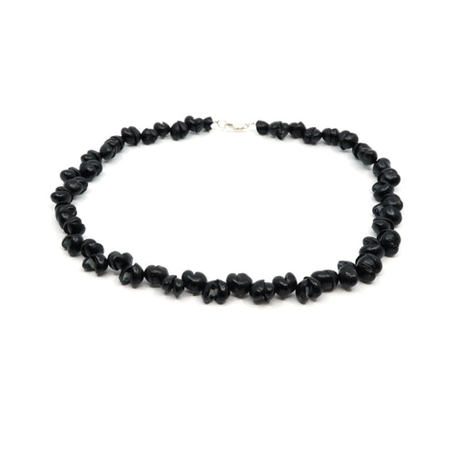Black shell necklace with silver clasp.