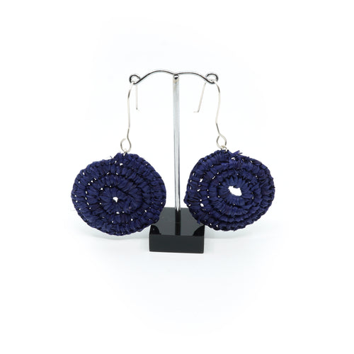 Raffia woven in spiral design, blue circles with silver hooks.