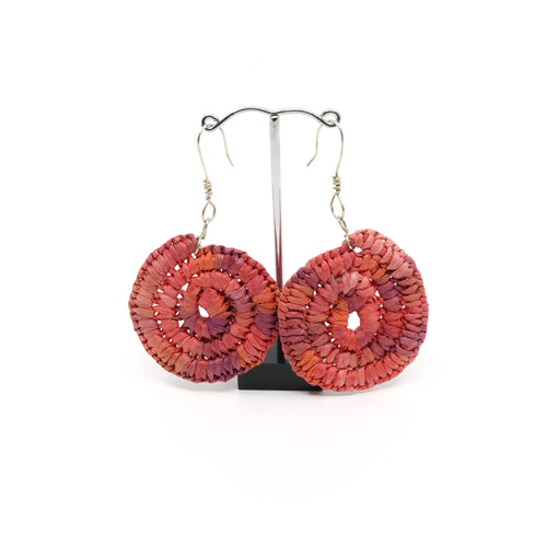 Raffia woven in spiral design, pink circles with silver hooks.