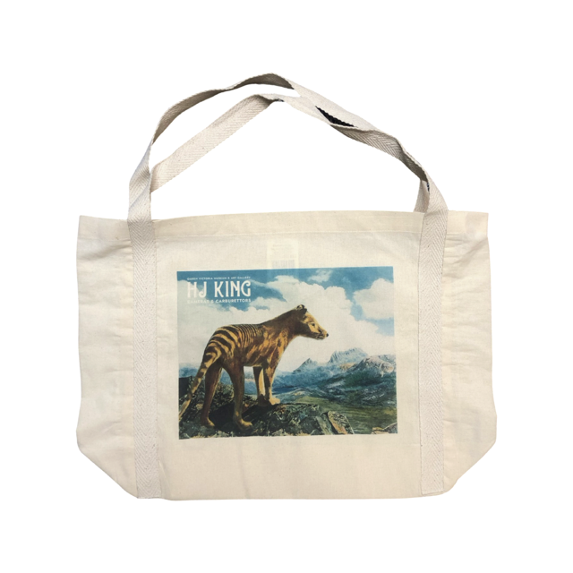 A tote bag with an image of a Thylacine looking towards Cradle Mountain.