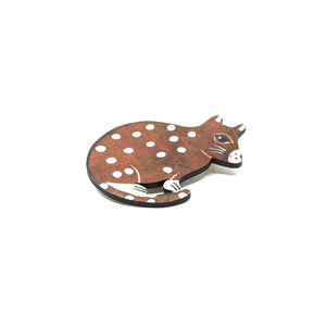 Wooden brown quoll brooch with white spots.