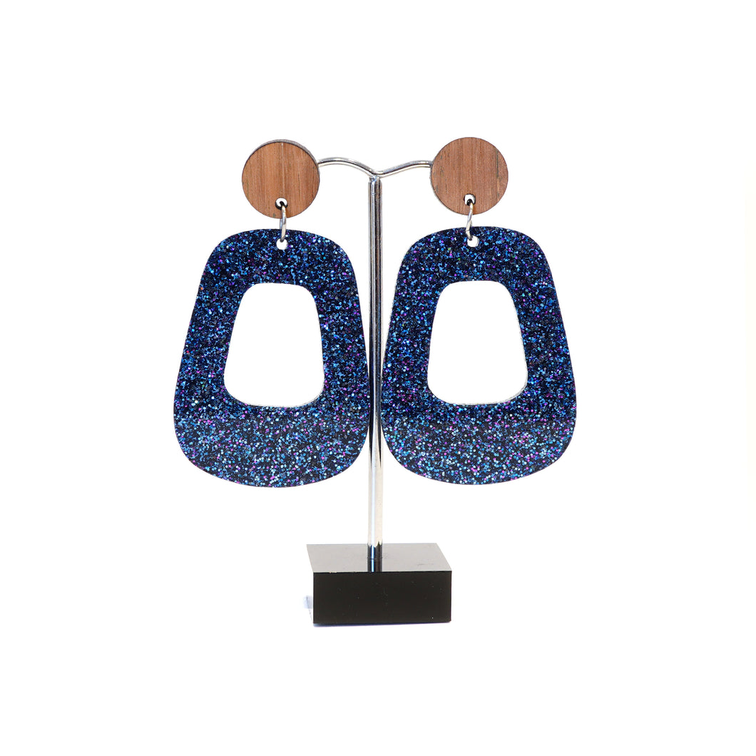 Blue sparkly retro hoops with wooden disc studs.