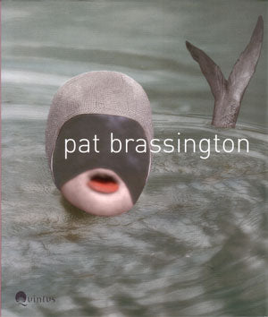 Photograph of face with swimming cap and fish tail in water.